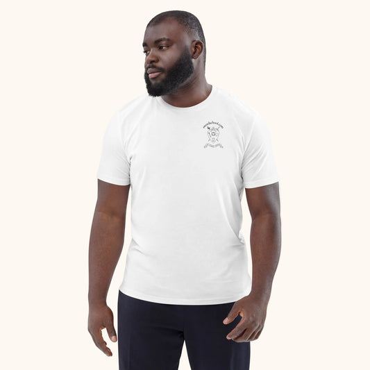 A man wearing a white Swordschool Classic T-shirt with a graphic on the chest, paired with dark pants.